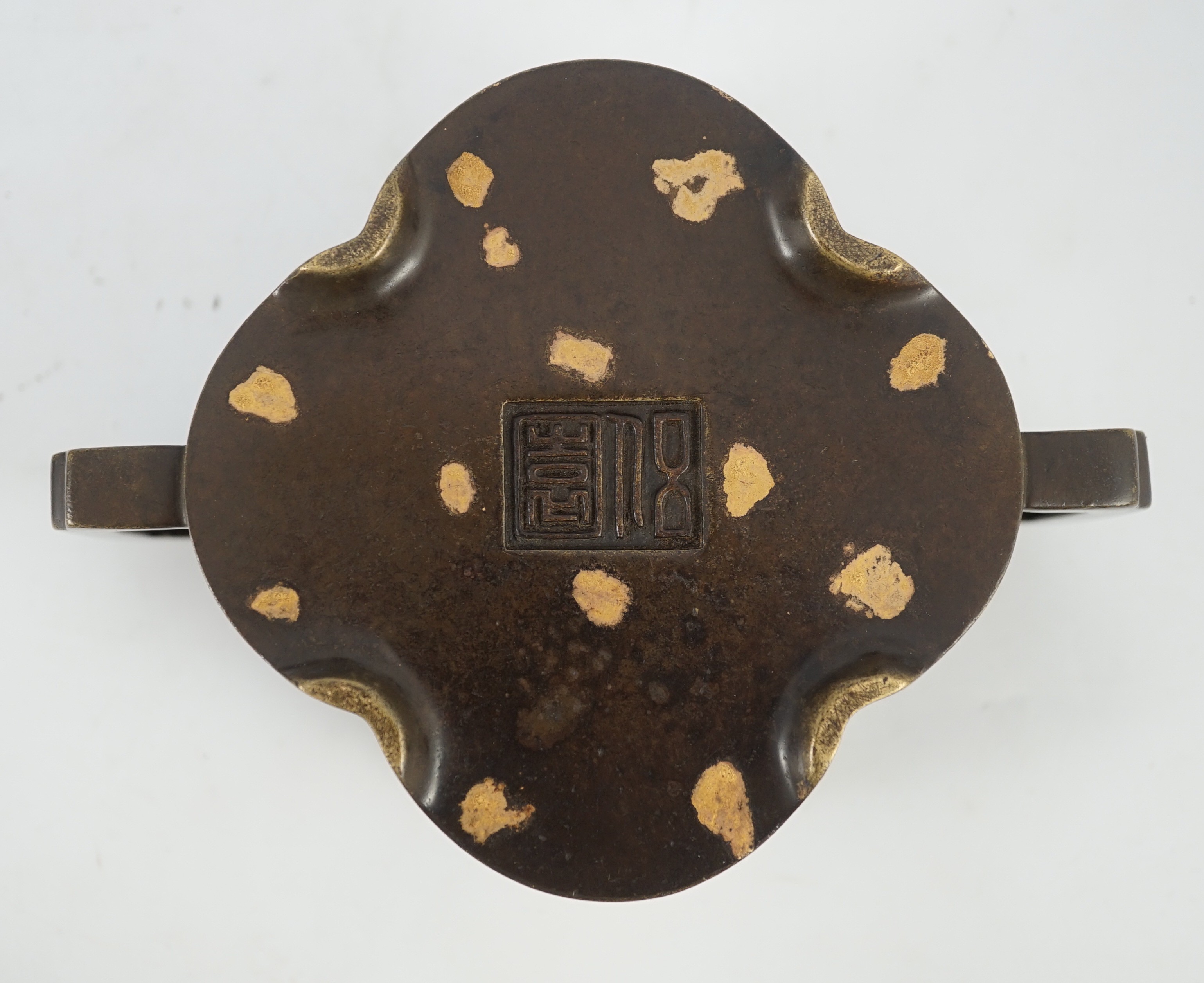 A Chinese gold splashed bronze quatrelobed censer, 17cm wide